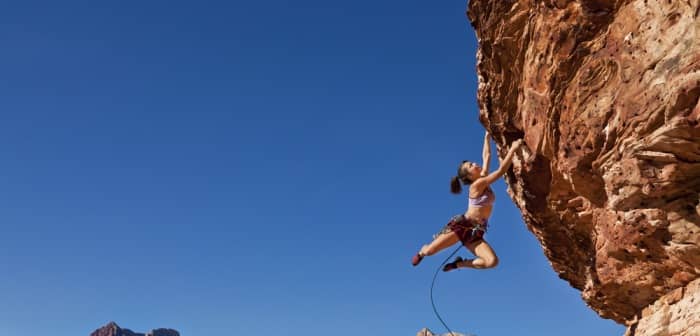 Women hanging doing rock climbing
