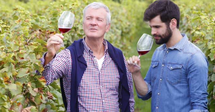 two men who are winemakers sipping wine