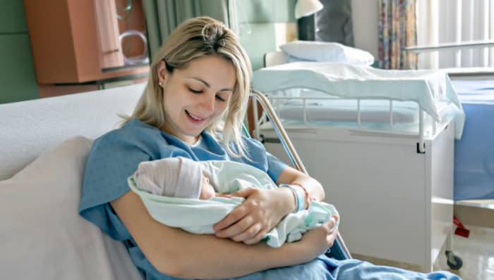 New mom holding baby in hospital