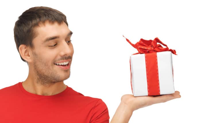 man red shirt holding up a gift