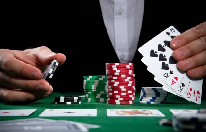 Poker player with chips to bet in hand