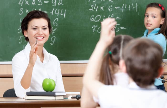 Teacher with an apple on her desk