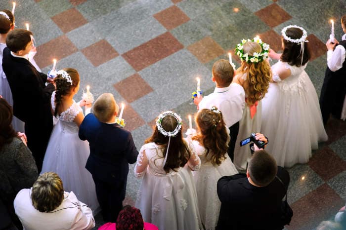 First holy communion in church, many little children