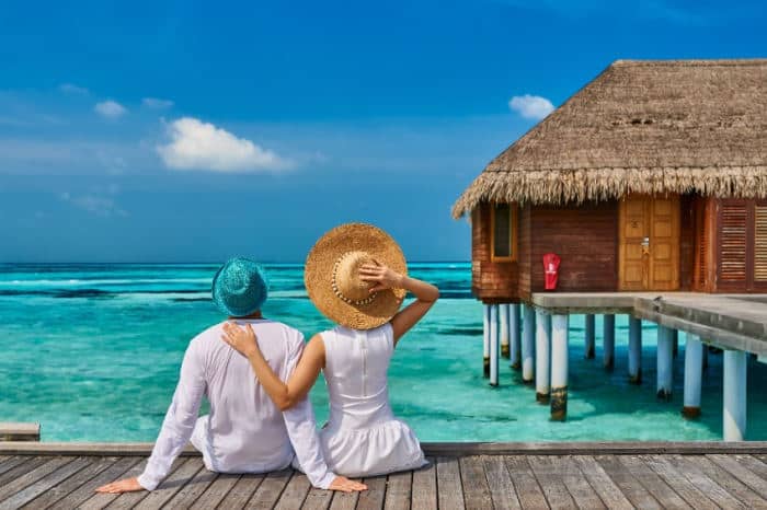 couple sitting on dock on their honeymoon