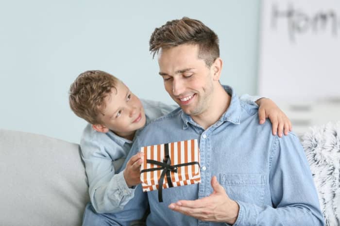 boy giving a gift to his dad