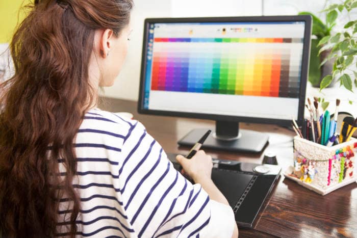 young female designer working with colors at home