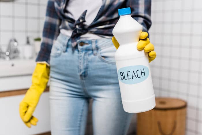 Women holding bleach to kill bed bugs