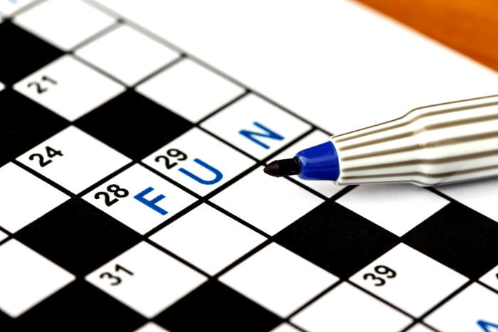 Fun in solving crossword puzzle, close up