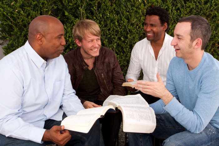 group of men studying the Bible together.