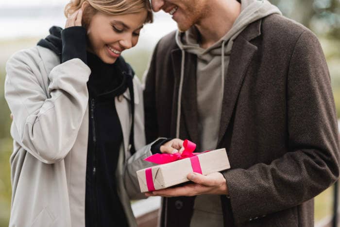 man giving a woman a gift for fall