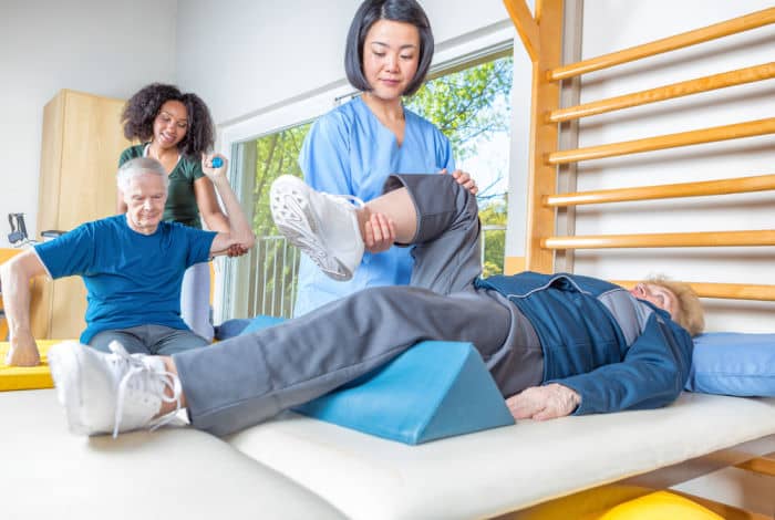 Physical therapist helping to rehab patients
