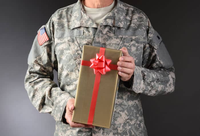 Man deployed for military holding gift